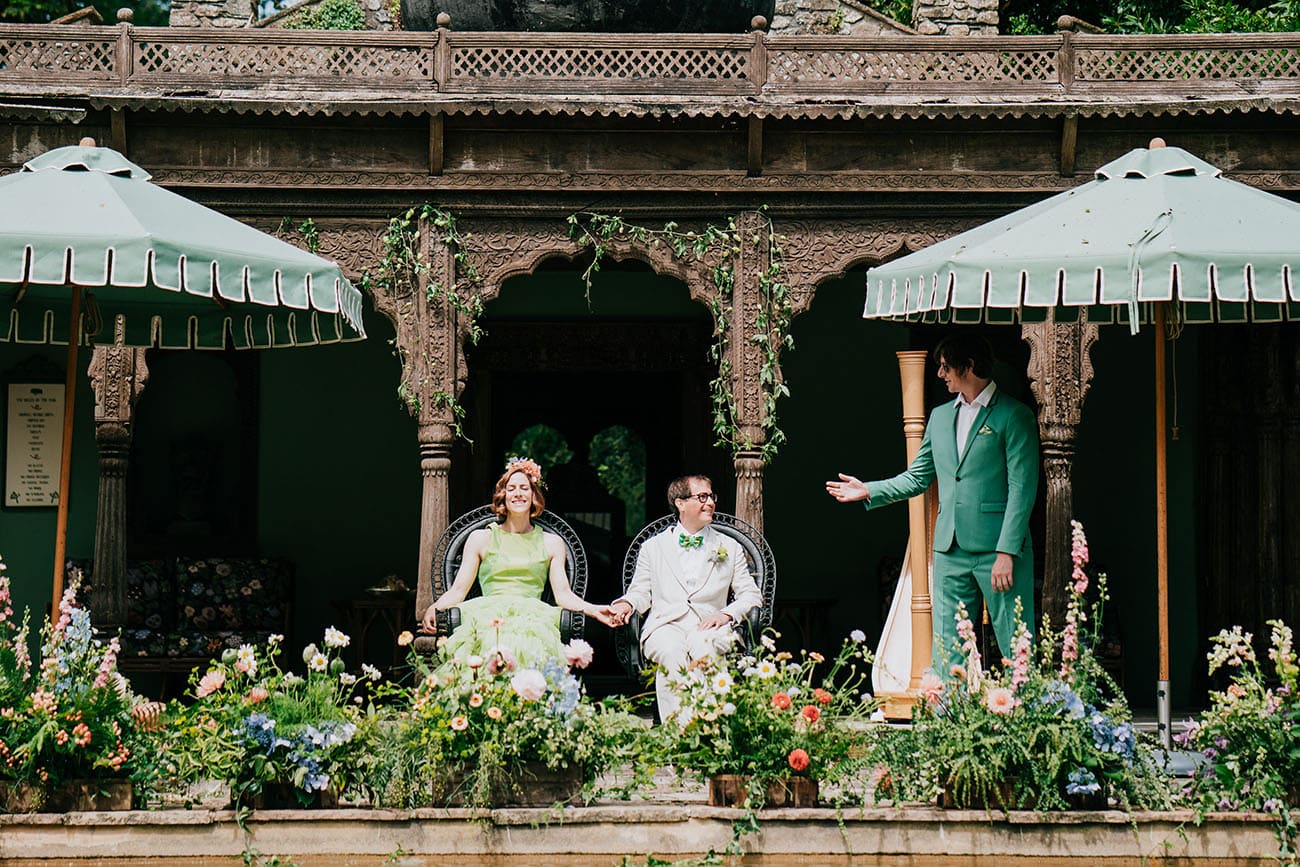 Bride in green bridal gown and groom during their outdoor wedding ceremony by the wedding venue's pool